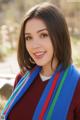 A beautiful young woman wearing a colorful scarf.