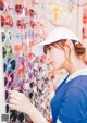 A woman looking at a display of heart shaped sunglasses.