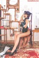 A woman sitting on a chair holding a mirror.